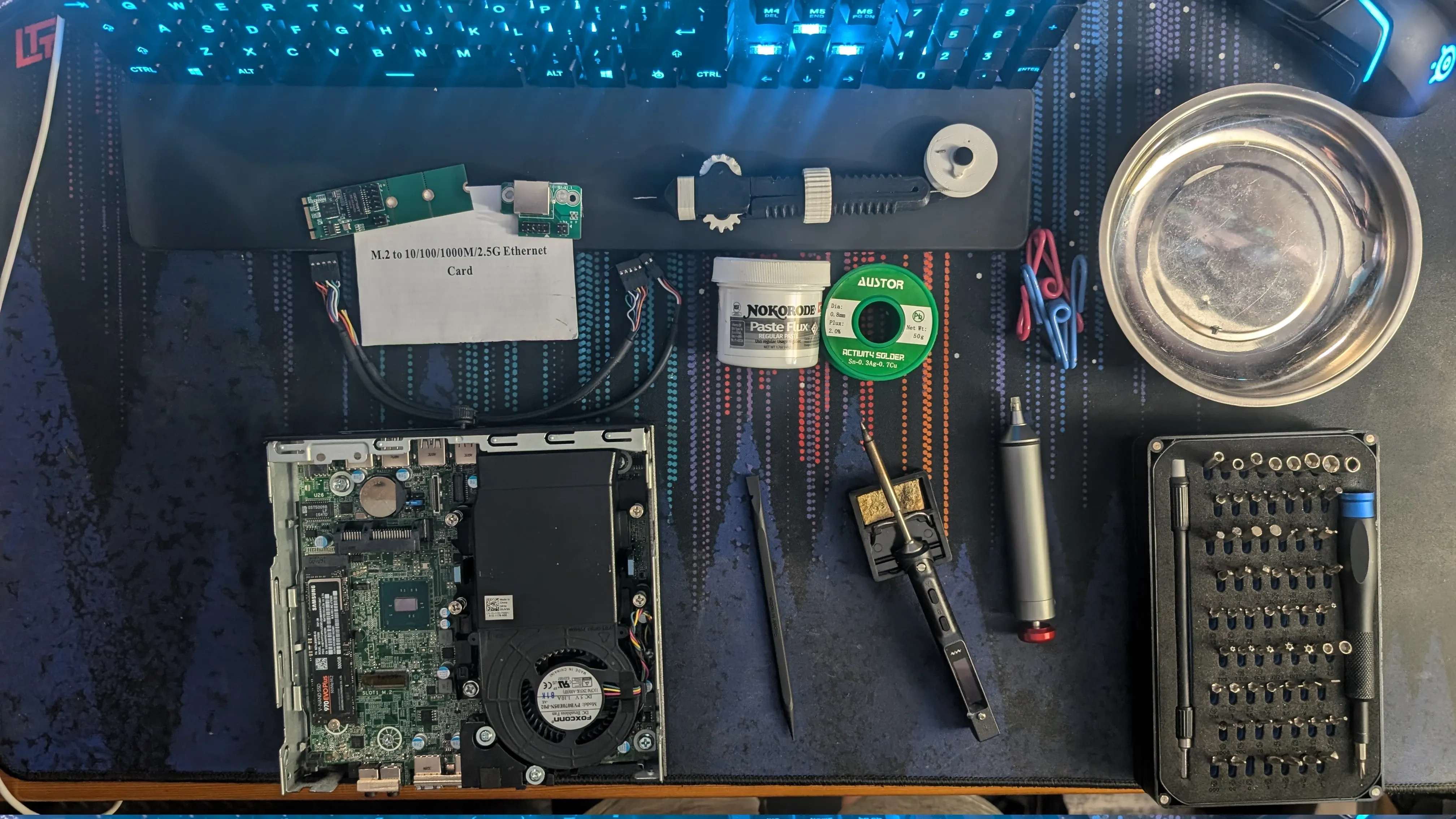 My desk covered in soldering hardware and one of the cluster nodes